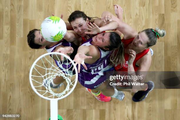 Chelsea Lewis and Caralea Moseley of Wales and Hayley Mulheron and Fiona Isobel Fowler of Scotland contest the ball in the Netball match between...