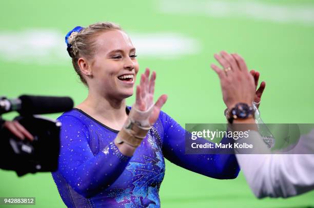 Elsabeth Black of Canada is congratulated as she wins gold in the Women's Individual All-Around Final during Gymnastics on day three of the Gold...