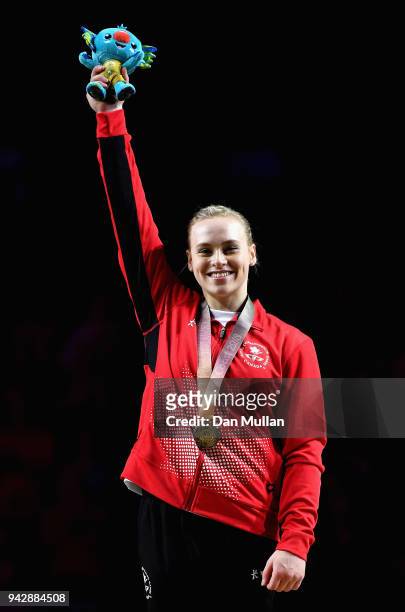Gold medalist Elsabeth Black of Canada celebrates during the medal ceremony for the Women's Individual All-Around Final during Gymnastics on day...