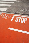 Orange bicycle lane with a STOP sign