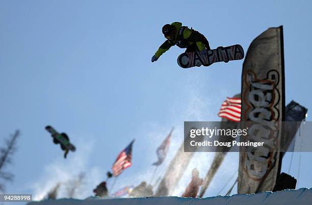 Competitors go airborne above the pipe during a practice session for the US Snowboarding Grand Prix Men's Qualifier on the Main Vein Half Pipe on...