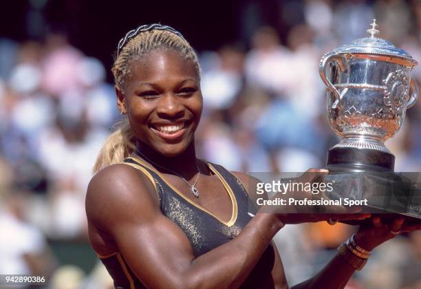 Serena Williams of the USA poses with the trophy after defeating her sister Venus Williams of the USA in the Women's Singles Final of the French Open...