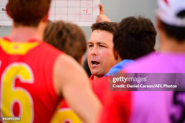 Stuart Dew, coach of the Suns addresses the team at quarter time during the 2018 AFL round 03 match between the Gold Coast Suns and the Fremantle...