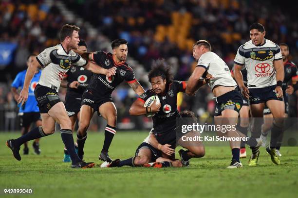 Bunty Afoa of the Warriors is tackled during the round five NRL match between the New Zealand Warriors and the North Queensland Cowboys at Mt Smart...