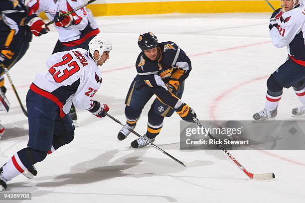 Tim Connolly of the Buffalo Sabres handles the puck against Milan Jurcina of the Washington Capitals on December 9, 2009 at HSBC Arena in Buffalo,...