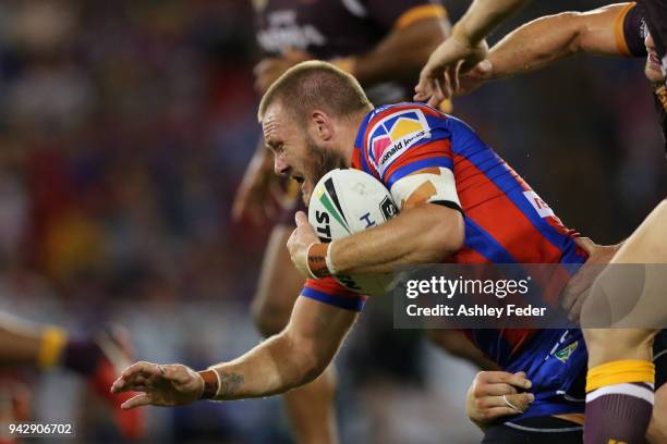 Nathan Ross of the Knights is tackled by the Broncos defence during the round five NRL match between the Newcastle Knights and the Brisbane Broncos...