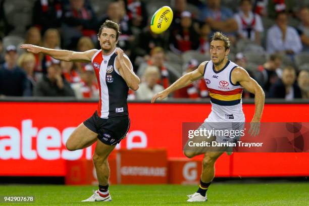 Dylan Roberton of the Saints Richard Douglas of the Adelaide Crows chase the ball during the round three AFL match between the St Kilda Saints and...