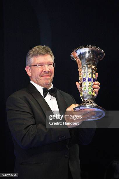 In this handout image provided by FIA, Brawn Team Principal Ross Brawn poses with the FIA Constructors Championship trophy during the 2009 FIA Gala...