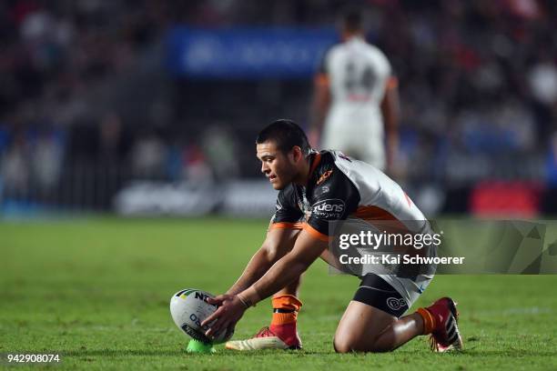 Tuimoala Lolohea of the Tigers looks to kick a conversion during the round five NRL match between the Wests Tigers and the Melbourne Storm at Mt...