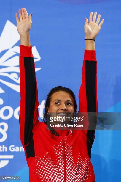 Gold medalist Kylie Masse of Canada poses during the medal ceremony for the Women's 100m Backstroke Final on day three of the Gold Coast 2018...