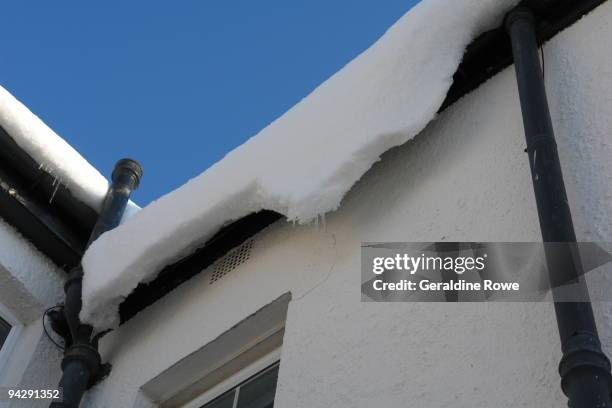 snow sliding off a roof - bromley stock pictures, royalty-free photos & images