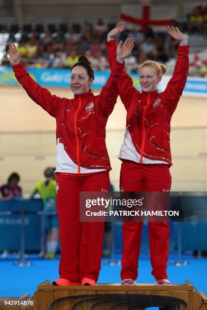 England's Sophie Thornhill and pilot Helen Scott react on the podium during the medal ceremony for their gold in the women's B&VI 1000m time trial...