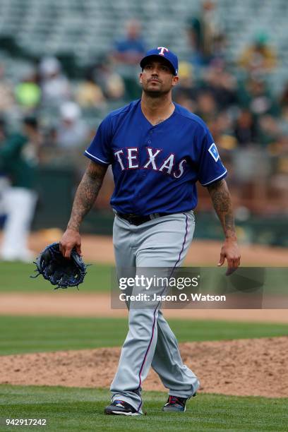 Matt Bush of the Texas Rangers returns to the dugout after being relieved against the Oakland Athletics during the seventh inning at the Oakland...