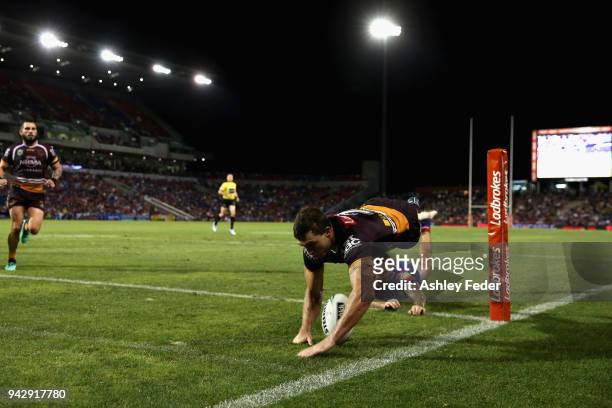 Corey Oates of the Broncos scores a try tackled by Shaun Kenny-Dowall of the Knights during the round five NRL match between the Newcastle Knights...