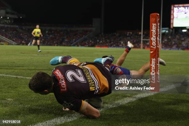 Corey Oates of the Broncos scores a try tackled by Shaun Kenny-Dowall of the Knights during the round five NRL match between the Newcastle Knights...