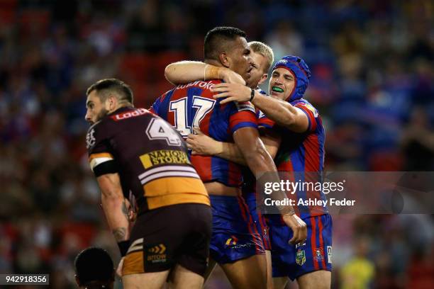 Daniel Saifiti of the Knights celebrates his try with team mates during the round five NRL match between the Newcastle Knights and the Brisbane...