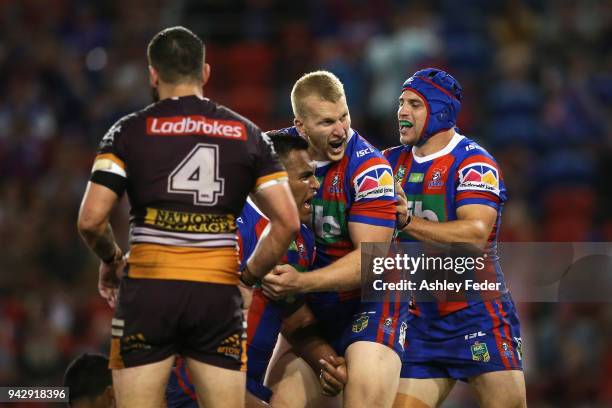 Daniel Saifiti of the Knights celebrates his try with team mates during the round five NRL match between the Newcastle Knights and the Brisbane...