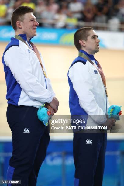 Scotland's Neil Fachie and pilot Matt Rotherham stand on the podium for their gold medal win during the medal ceremony for the men's B&VI sprint...