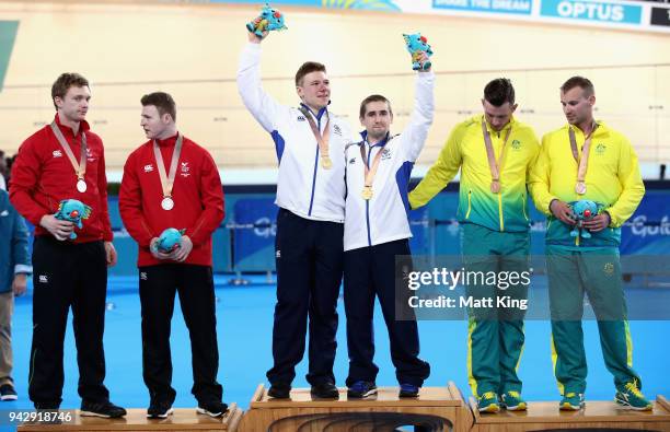 Silver medalists James Ball of Wales and pilot Peter Mitchell, gold medalists Neil Fachie of Scotland and pilot Matt Rotherham and bronze medalists...