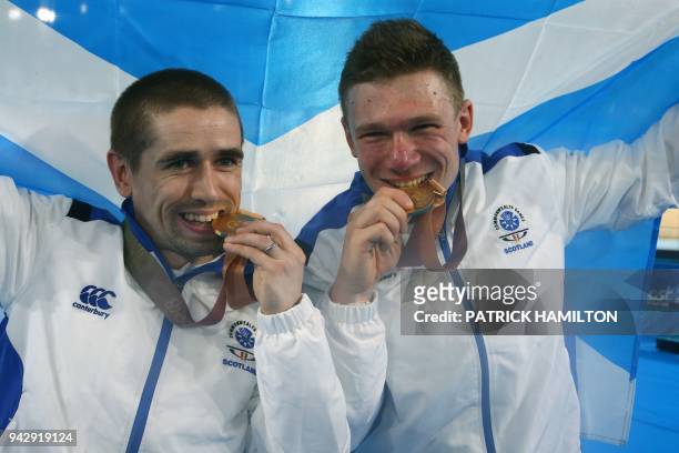 Scotland's Neil Fachie and pilot Matt Rotherham celebrate with their gold medals after the medal ceremony for the men's B&VI sprint finals cycling...