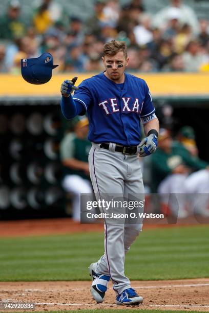 Ryan Rua of the Texas Rangers reacts after striking out against the Oakland Athletics during the fourth inning at the Oakland Coliseum on April 5,...