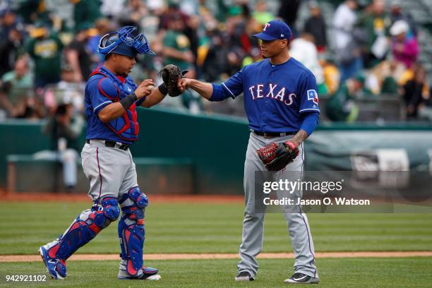 Keone Kela of the Texas Rangers celebrates with Juan Centeno after the game against the Oakland Athletics at the Oakland Coliseum on April 5, 2018 in...