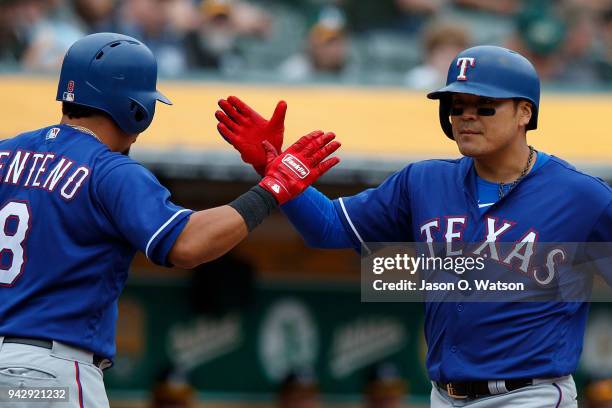 Shin-Soo Choo of the Texas Rangers is congratulated by Juan Centeno after hitting a two run home run against the Oakland Athletics during the ninth...