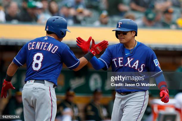 Shin-Soo Choo of the Texas Rangers is congratulated by Juan Centeno after hitting a two run home run against the Oakland Athletics during the ninth...