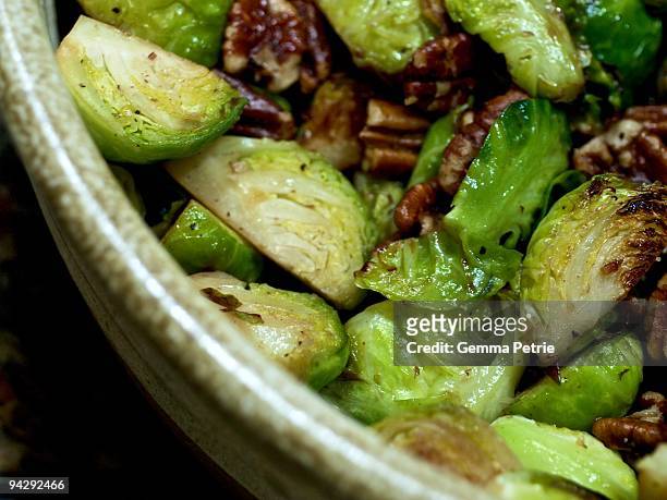 roasted brussels sprouts with pecans - bowls of side dishes roast fotografías e imágenes de stock
