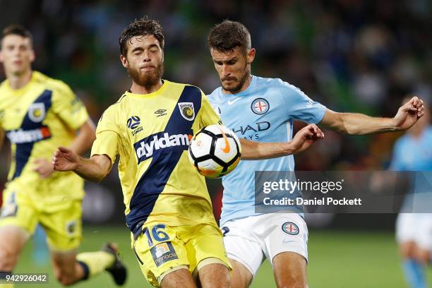 Liam Rose of Central Coast Mariners and Dario Vidosic of Melbourne City contest the ball during the round 26 A-League match between Melbourne City...