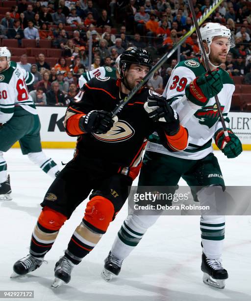 Adam Henrique of the Anaheim Ducks battles for position against Nate Prosser of the Minnesota Wild during the game on April 4, 2018 at Honda Center...