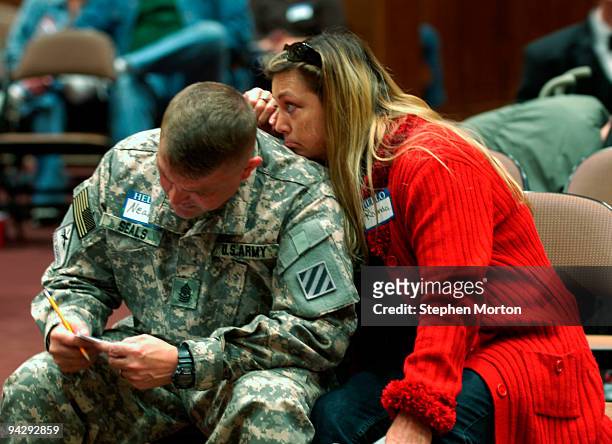 Army 1st Heavy Brigade Combat Team Sgt. Major Neal Seals fills out commitment card while his wife Rhonda waits for him to finish as part of the Coin...