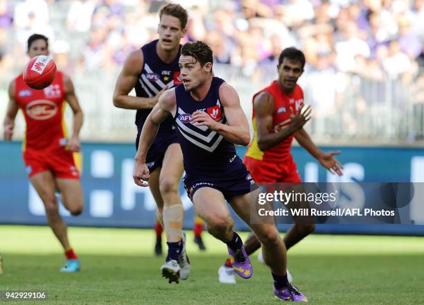 Lachie Neale of the Dockers chases the ball during the round three AFL match between the Gold Coast Suns and the Fremantle Dockers at Optus Stadium...