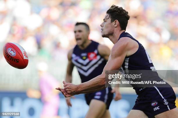 Lachie Neale of the Dockers handpasses the ball during the round three AFL match between the Gold Coast Suns and the Fremantle Dockers at Optus...