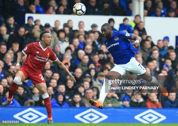 Everton's French striker Yannick Bolasie and Liverpool's English defender Nathaniel Clyne go for a high ball during the English Premier League...