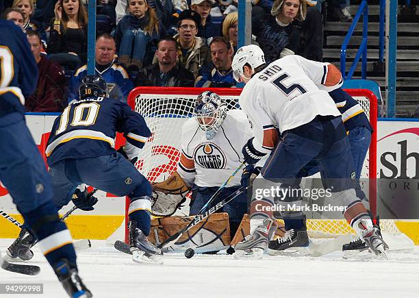 Jeff Deslauriers and Ladislav Smid of the Edmonton Oilers defend against Andy McDonald of the St. Louis Blues on December 11, 2009 at Scottrade...