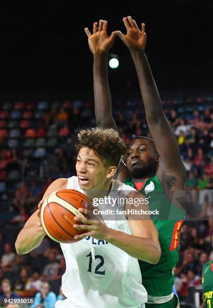 Sean Nealon-Lino of Scotland drives to the basket past Ebaku Nzoh Akumenzoh of Cameroon during the Preliminary Basketball round match between...