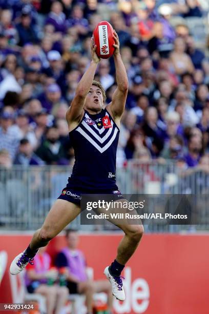 Mitchell Crowden of the Dockers takes an overhead mark during the round three AFL match between the Gold Coast Suns and the Fremantle Dockers at...