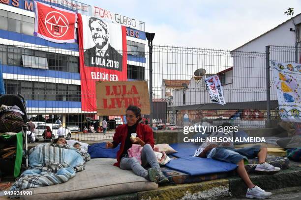 Supporters of former Brazilian president Luiz Inacio Lula da Silva sleep outside the metalworkers' union building in Sao Bernardo do Campo, in...