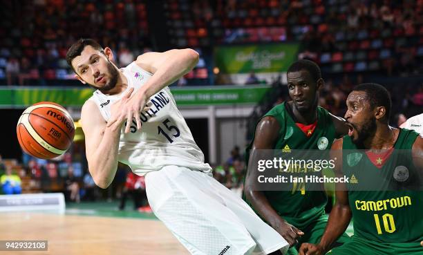 Alasdair Fraser of Scotland has his shot blocked by Pierre Cedric Essome of Cameroon during the Preliminary Basketball round match between Scotland...