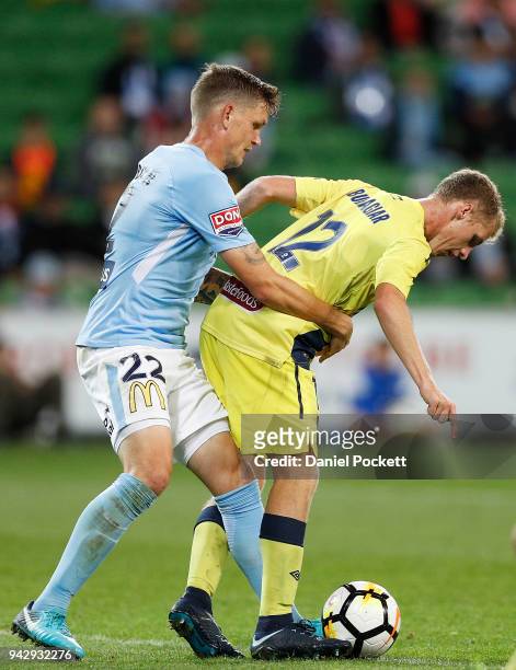 Trent Buhagiar of Central Coast Mariners and Michael Jakobsen of Melbourne City contest the ball during the round 26 A-League match between Melbourne...
