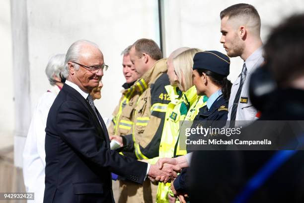 Archbishop Antje Jackeln and Carl XVI Gustaf of Sweden greets rescue workers during a tribute to victims of Stockholm terrorist attack on the first...