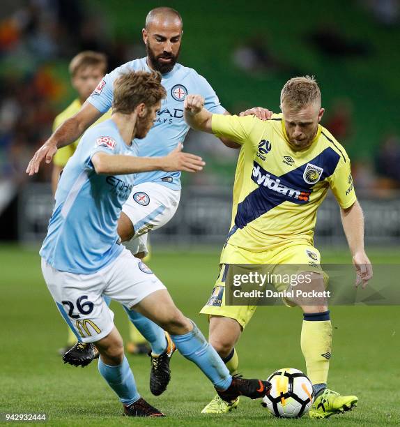 Connor Pain of Central Coast Mariners and Luke Brattan of Melbourne City contest the ball during the round 26 A-League match between Melbourne City...