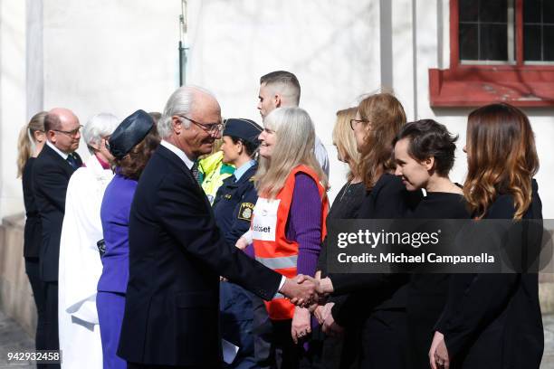 Archbishop Antje Jackeln and Carl XVI Gustaf of Sweden greets rescue workers during a tribute to victims of Stockholm terrorist attack on the first...