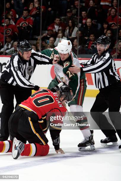 Brian McGratton of the Calgary Flames fights Derek Boogaard of the Minnesota Wild on December 11, 2009 at Pengrowth Saddledome in Calgary, Alberta,...