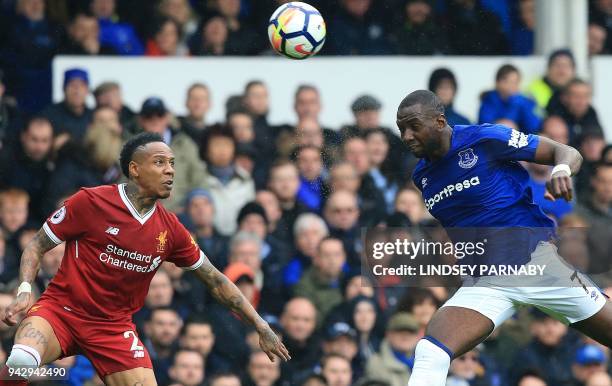 Everton's French striker Yannick Bolasie and Liverpool's English defender Nathaniel Clyne go for a high ball during the English Premier League...