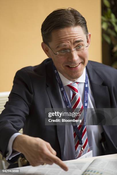 Jyrki Katainen, vice president of the European Commission, gestures at a newspaper during the 29th edition of "The Outlook for the Economy and...