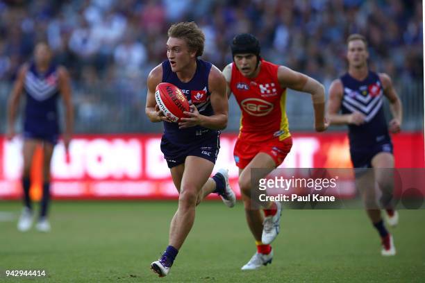 Mitchell Crowden of the Dockers runs onto the ball during the round three AFL match between the Gold Coast Suns and the Fremantle Dockers at Optus...