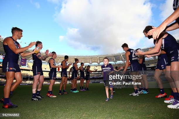 The Dockers form a guard of honour as the Starlight kids walk from the field during the round three AFL match between the Gold Coast Suns and the...
