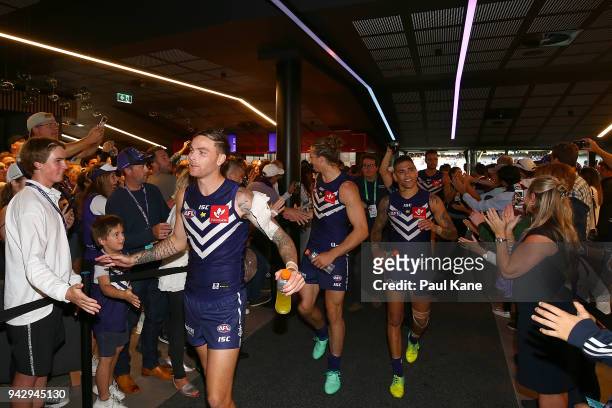 Nathan Wilson, Nathan Fyfe and Michael Walters of the Dockers walk thru the Locker Room after winning the round three AFL match between the Gold...
